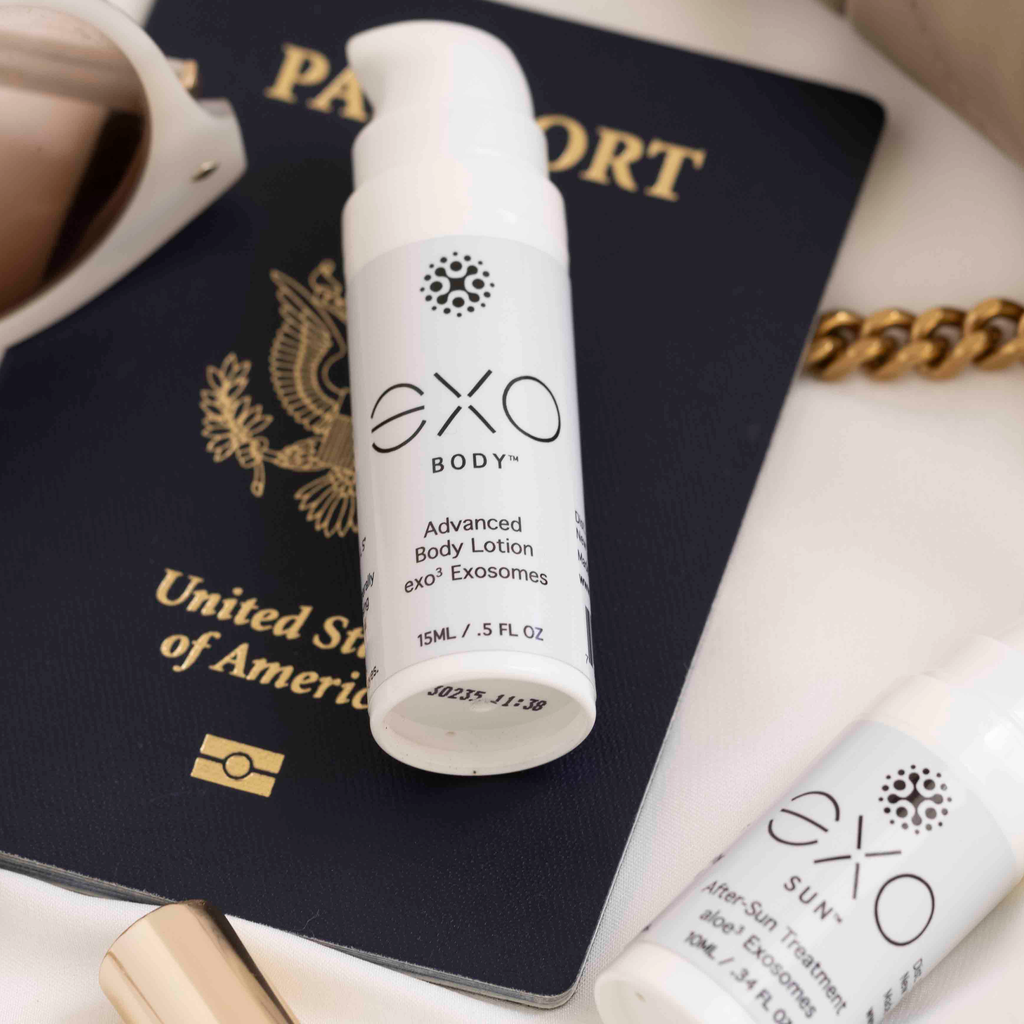 EXO Body Advanced Body Lotion on a passport with a cup and bracelet in the background
