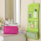Green hanging toiletry bag with pink pouch on a bathroom counter