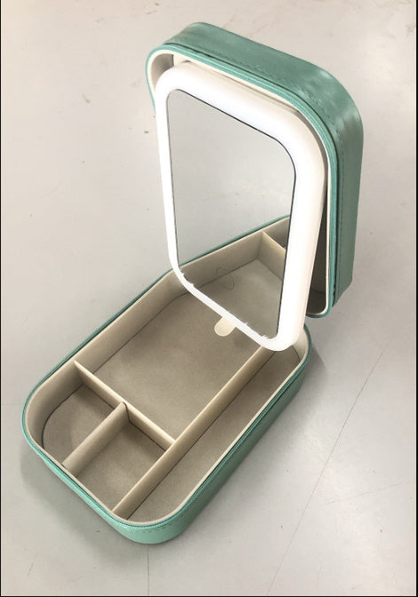Green jewelry box with a mirror on a white background