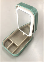 Green jewelry box with a mirror on a white background