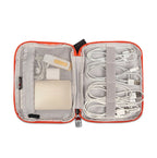 Open travel organizer with electronic accessories on a white background