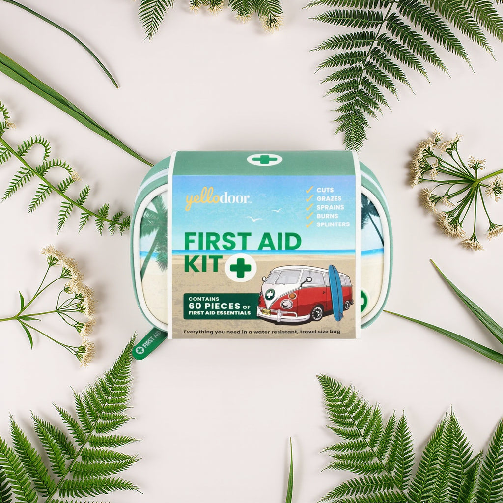 First aid kit with a retro van design on a white background with green leaves and flowers.