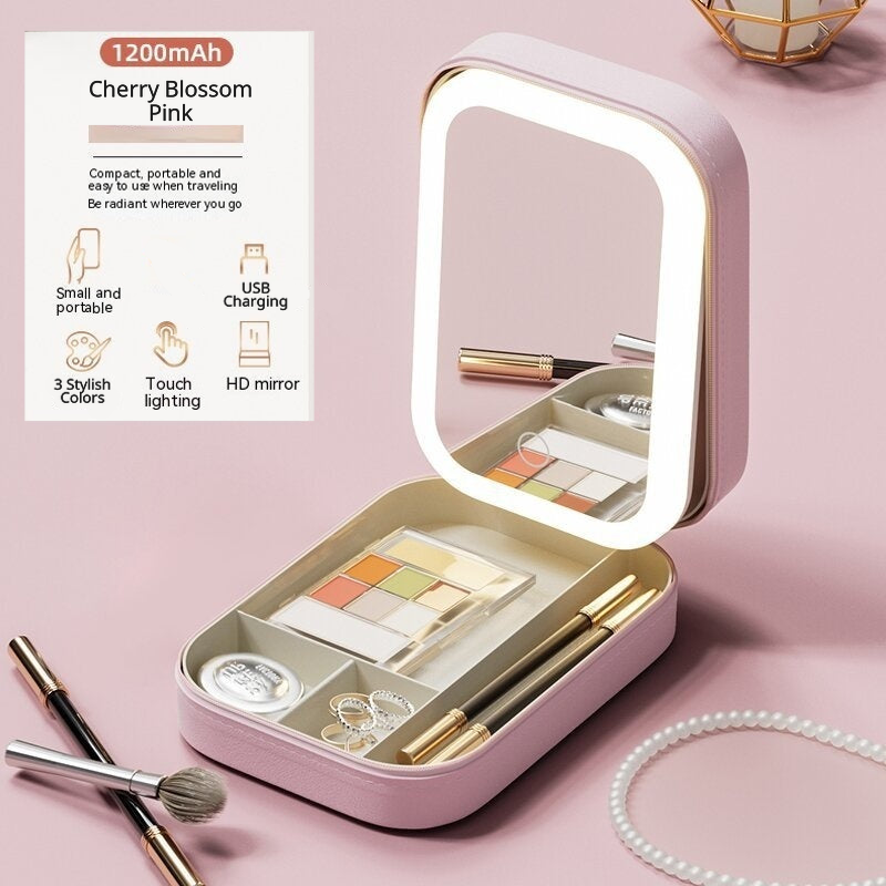 Cherry Blossom Pink makeup case with illuminated mirror on a pink background. Text shows features: small and portable, USB charging, 3 stylish colors, touch-lighting, and HD mirror.
