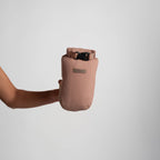 Person holding a quartz drawstring bag against a light gray background