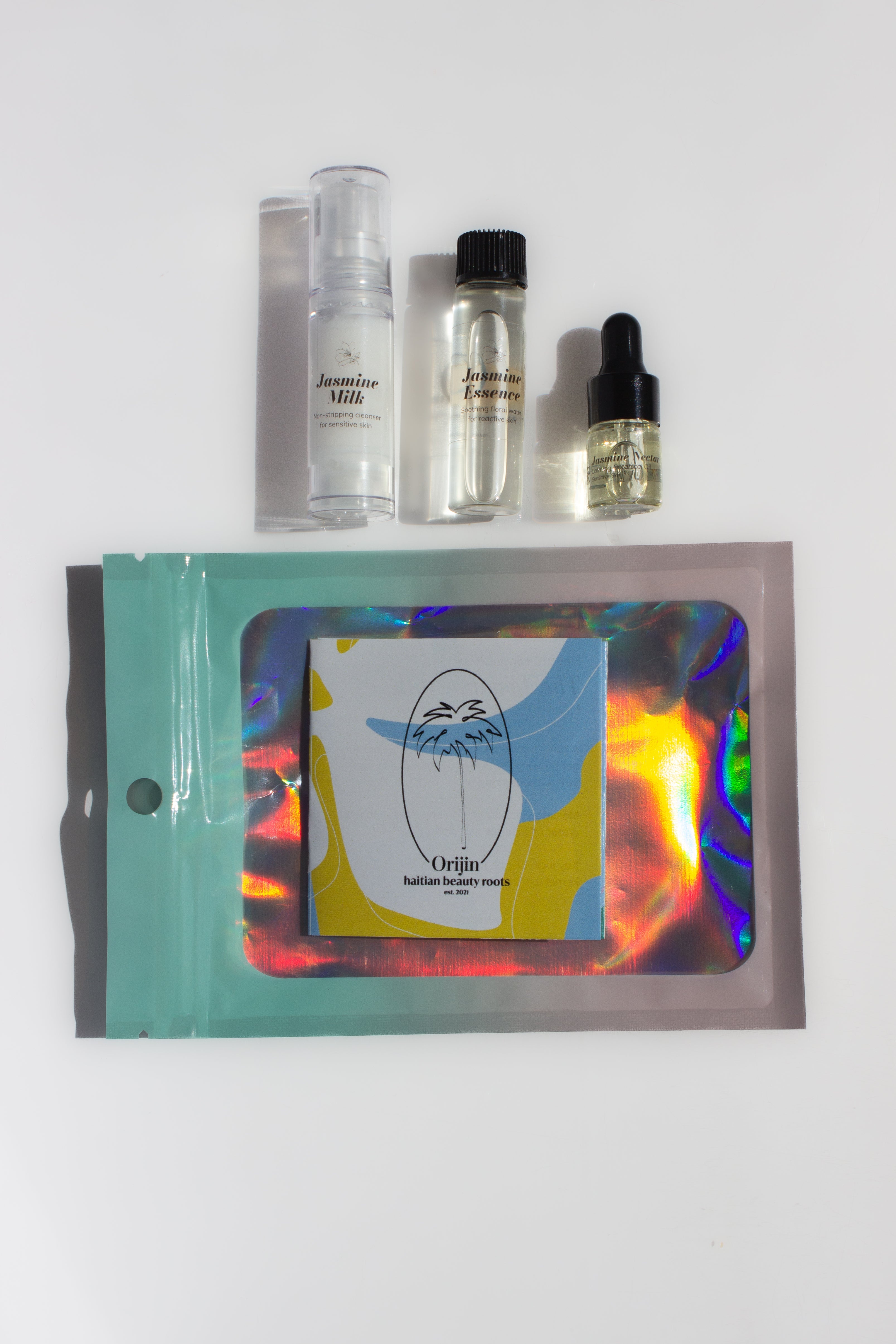 Set of skincare products including bottles and a pouch on a white background