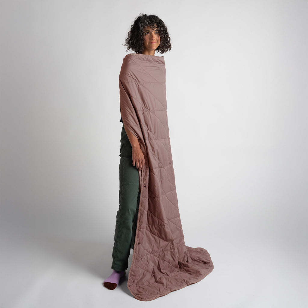 Person wearing a long, quartz quilted garment against a white background