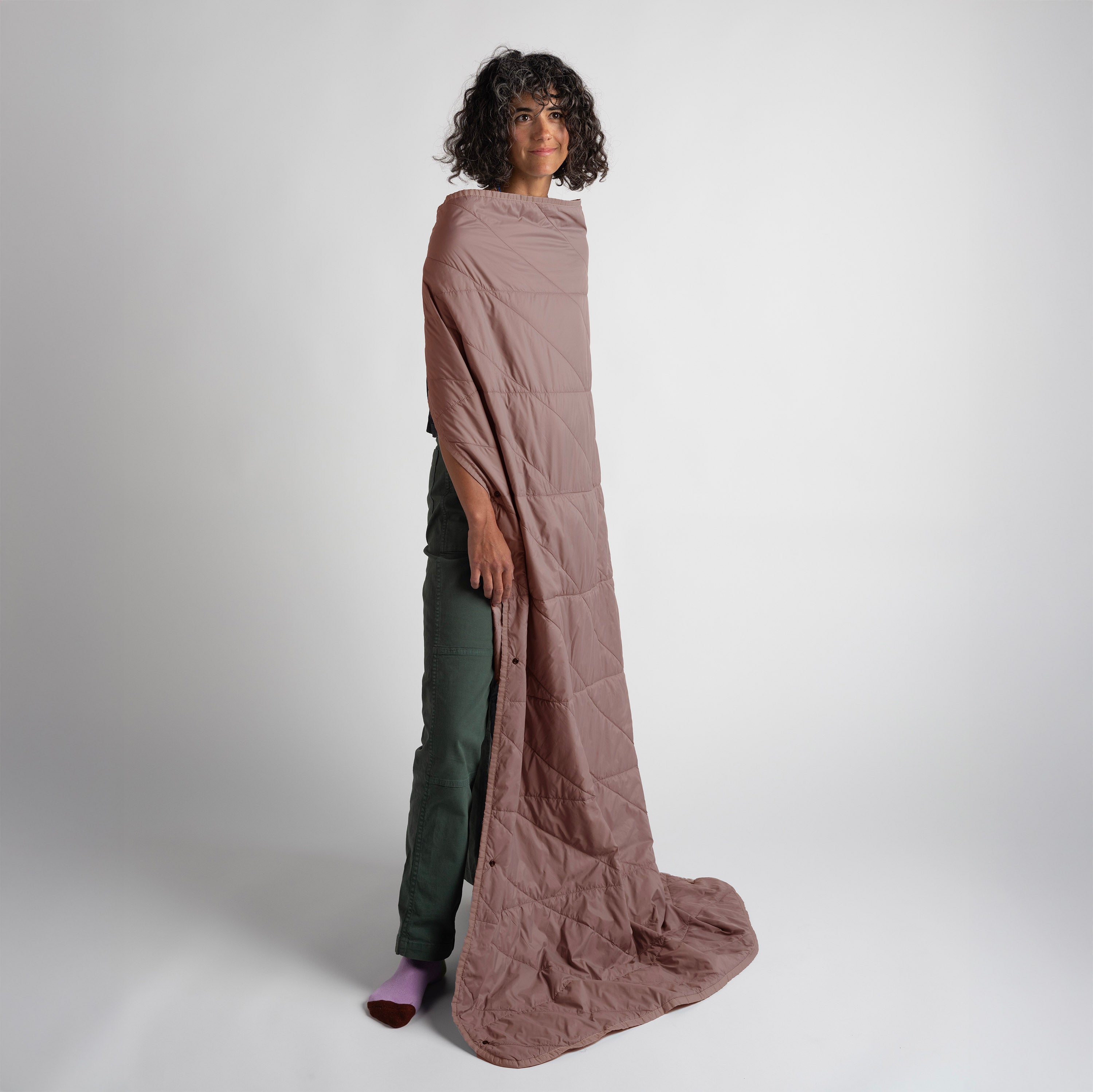 Person wearing a long, quartz quilted garment against a white background