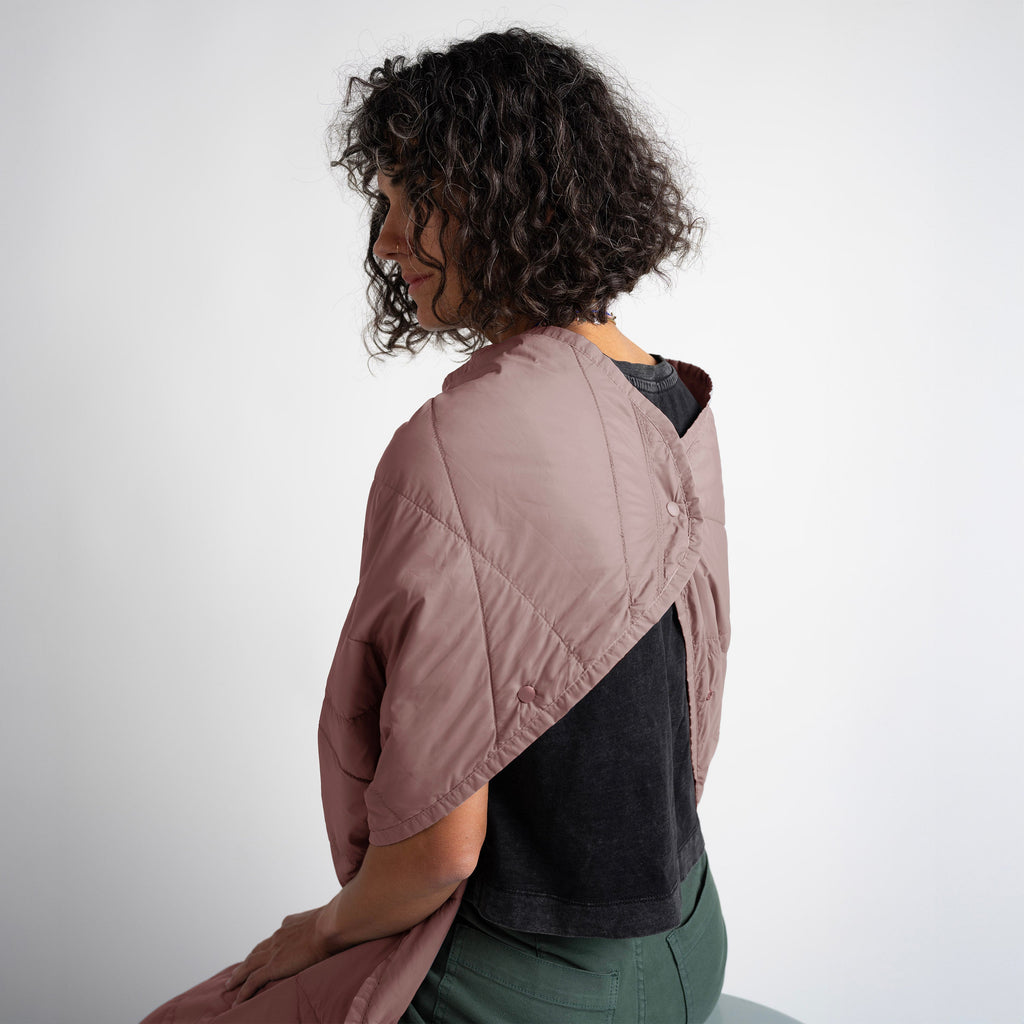 Person wearing a two-tone jacket with a plain background