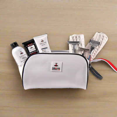 White travel shaving kit with various items on a transparent background