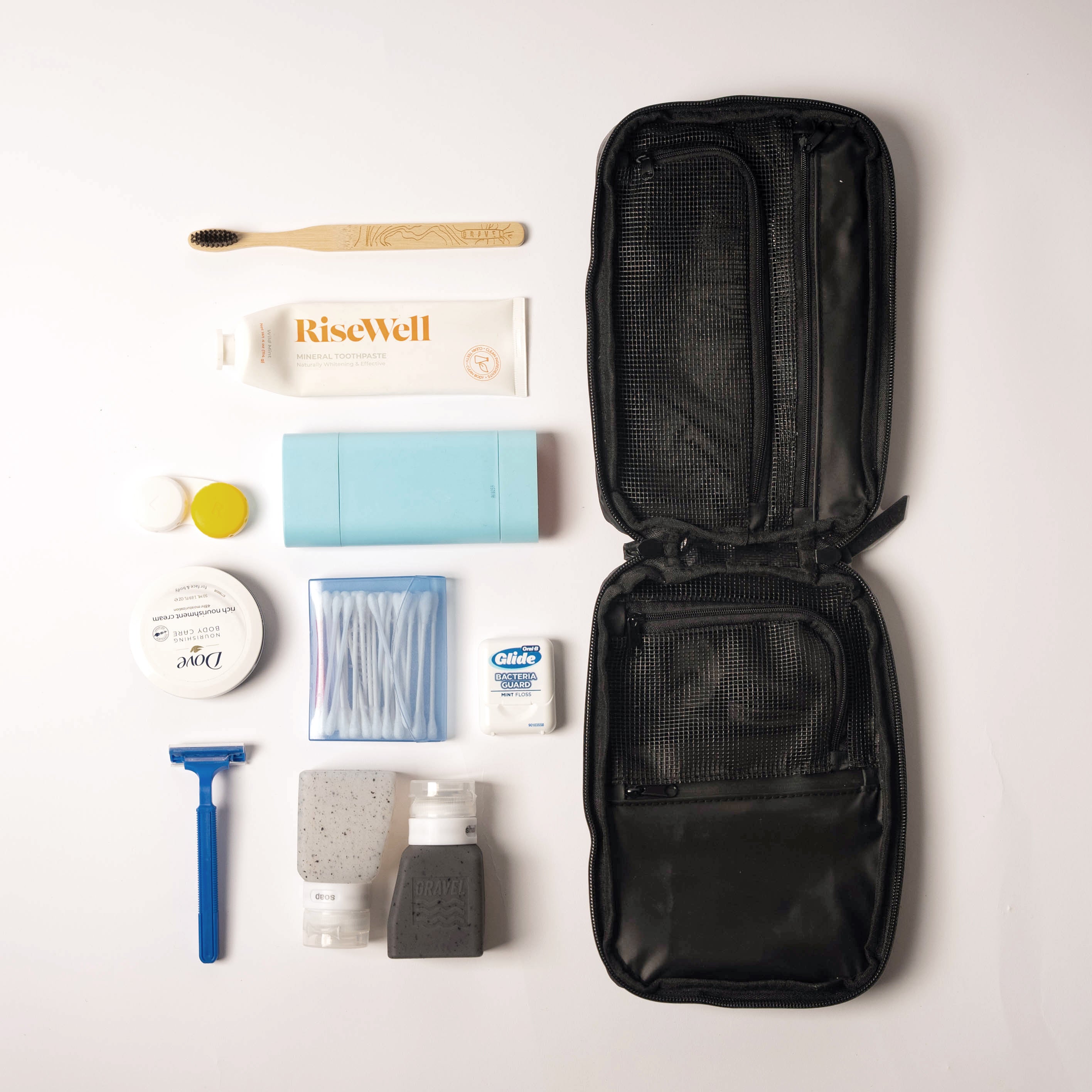 Travel grooming kit with open black case on a white background
