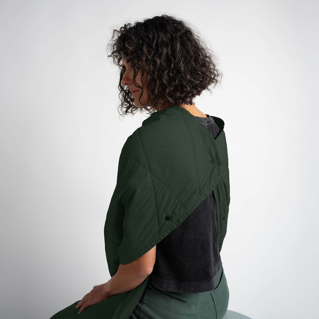 Person wearing a green and black two-tone jacket on a white background