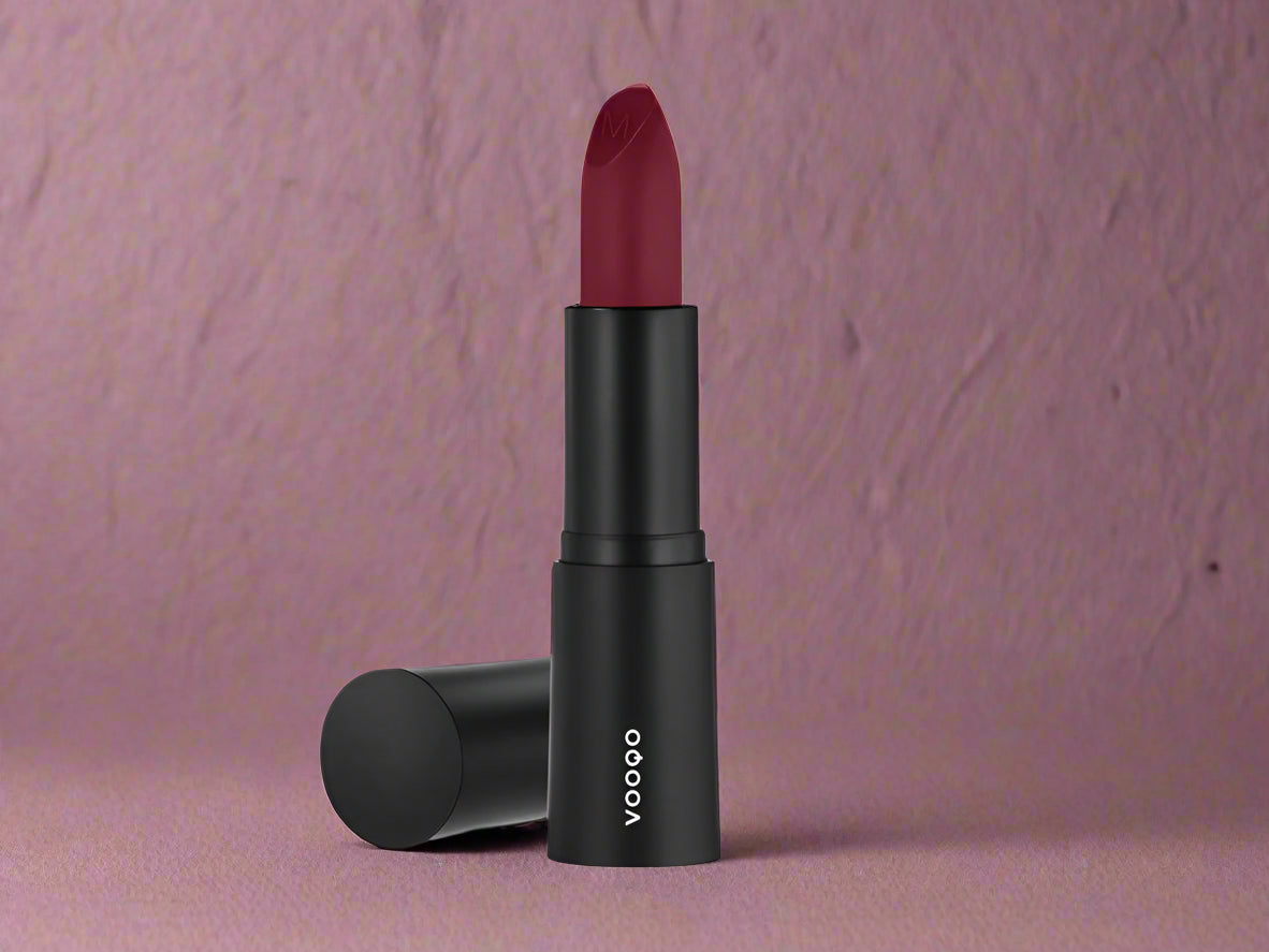Vooqo Lipstick in Courtesan shade, shown in sleek tube with swatch of deep wine satin color