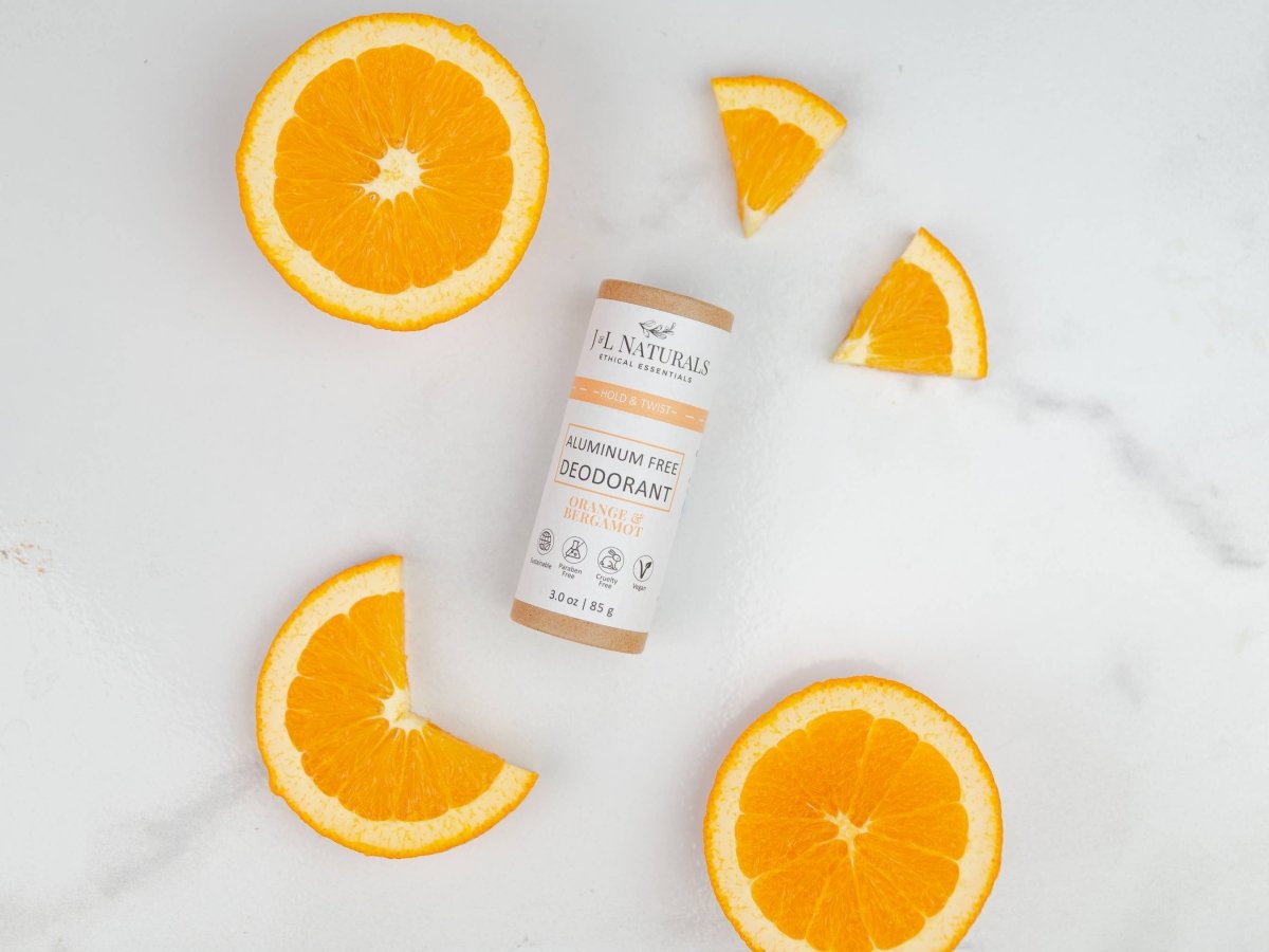 Aluminum-Free Deodorant by J&L Naturals – Plant-Powered Odor Control (3 oz) with fresh orange slices for travel size essentials.