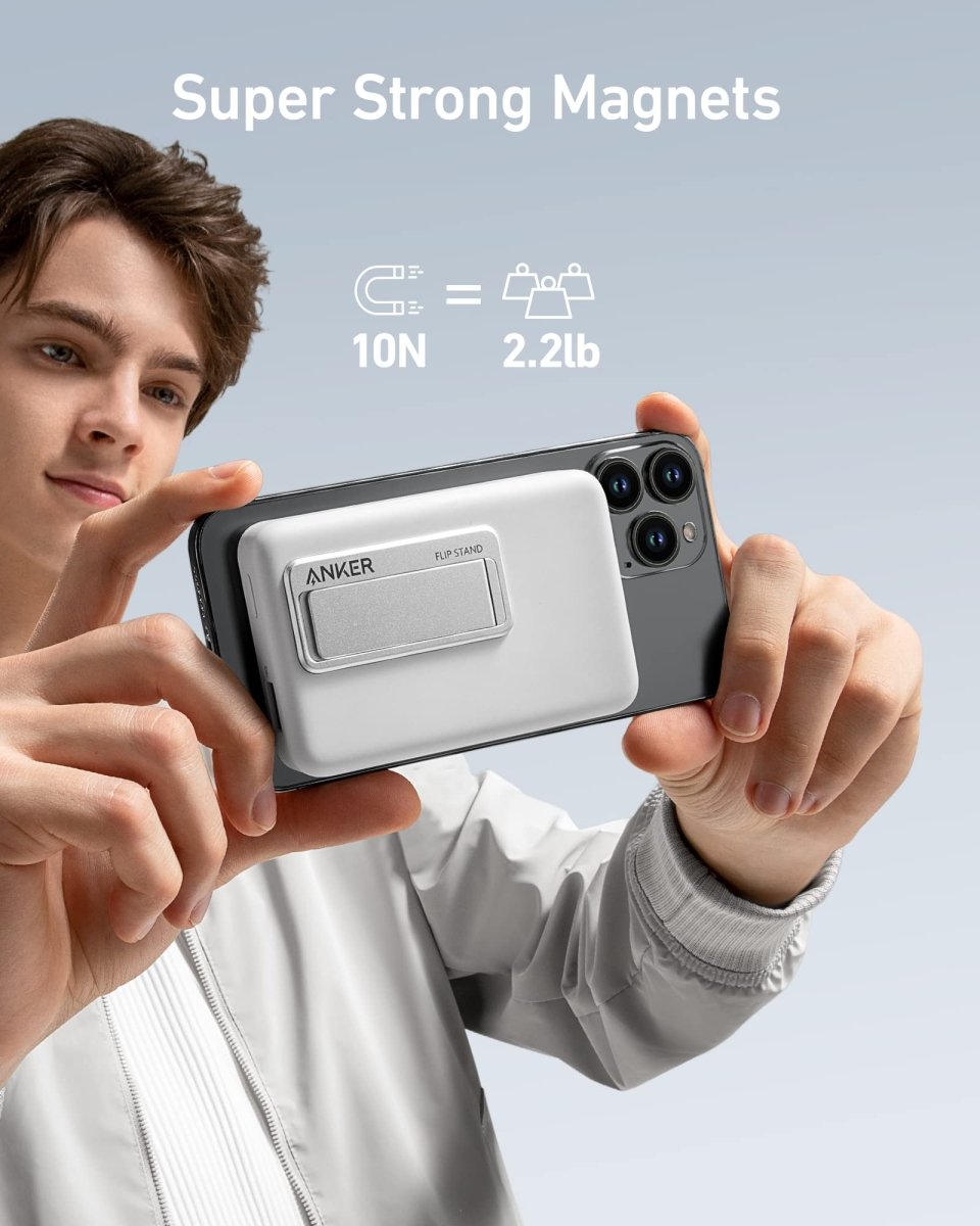 Person holding a phone with a magnetic stand, featuring Anker branding, on a light gray background.