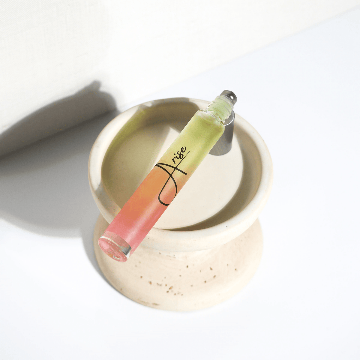 Lip gloss with a gradient color on a white surface