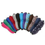 Row of colorful sleep masks with various patterns on a white background