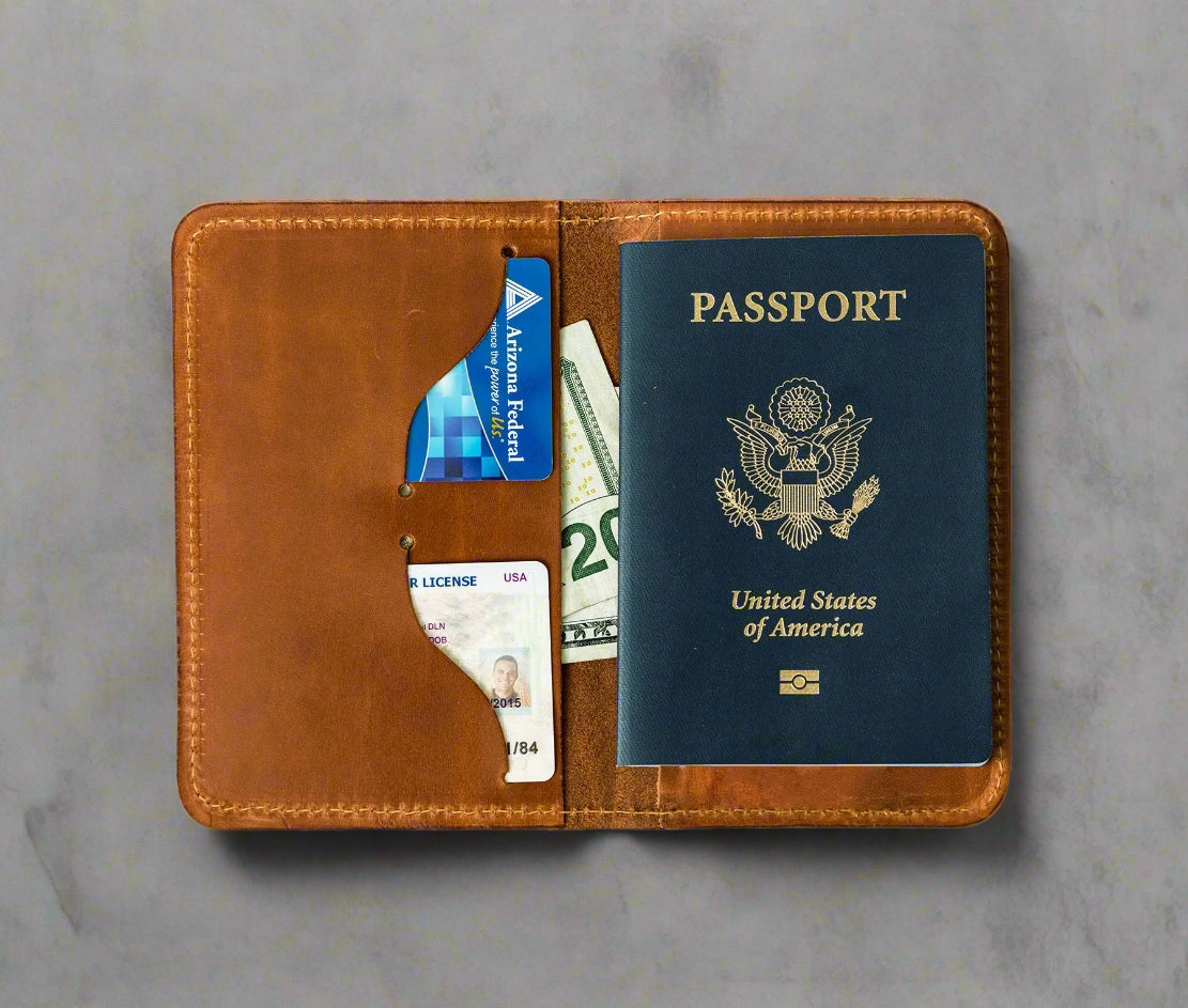 Full grain leather passport cover shown open with cards and travel papers inside
