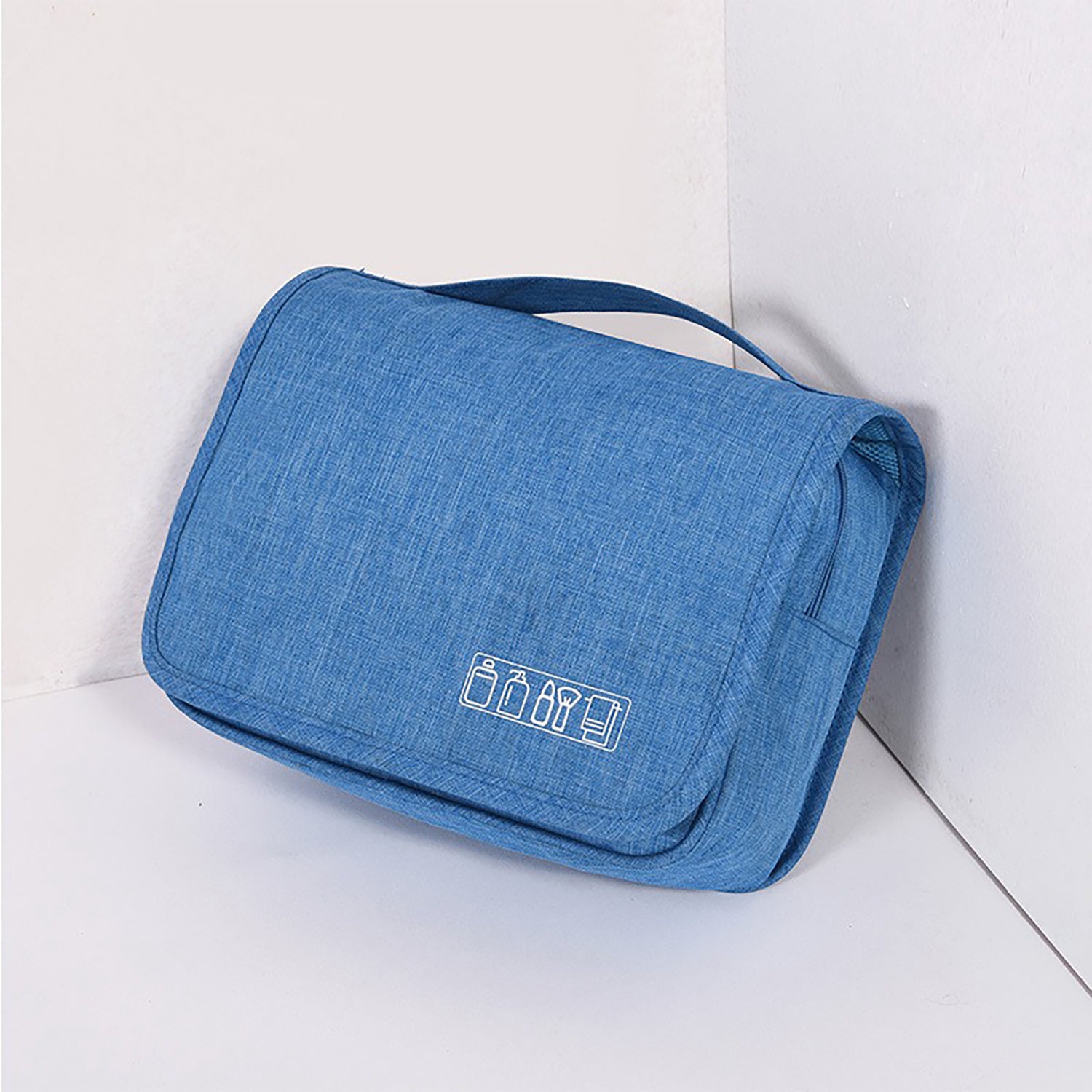Blue toiletry bag with travel icon on a white background