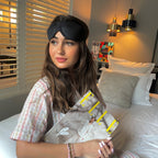 ELLE Contoured Sleep Mask worn by woman with magazine