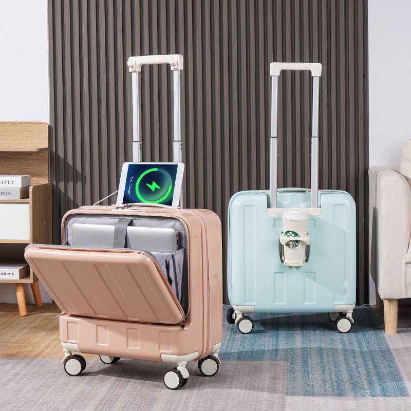 Two suitcases, one pink and one light blue, with electronic devices inside on a carpeted floor.