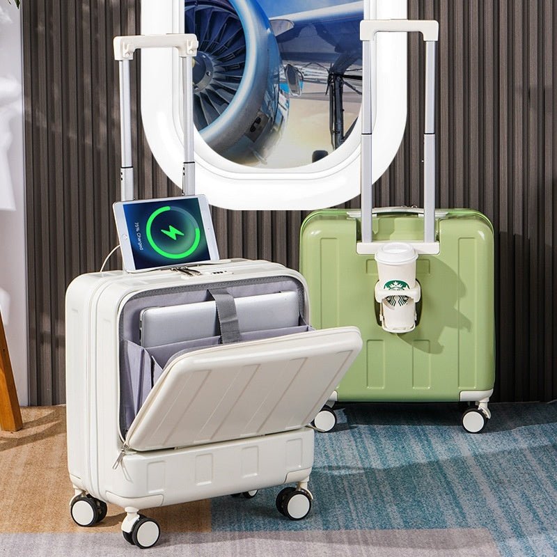 Two suitcases, one white and one green, with a laptop on top of the white suitcase in front of an airplane model.