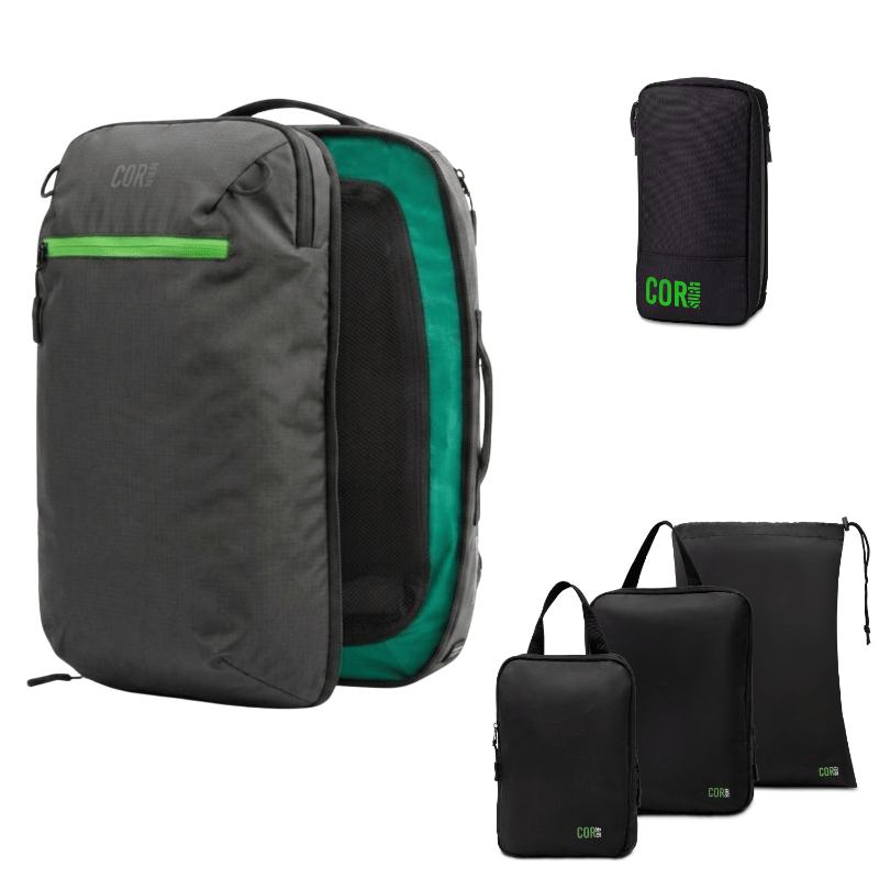 A dark gray and green Corepack backpack shown open, alongside three black compression sleeves of different sizes and a small black pouch with a green Corepack logo, all on a white background.