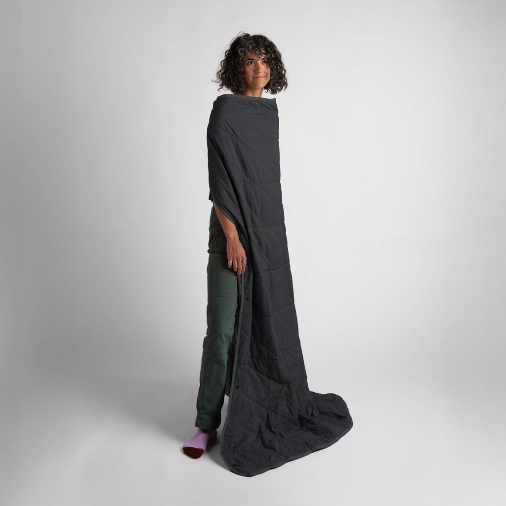 Layover™ Travel Blanket - Packable & Puffy | Black model wearing