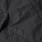 Close-up texture of Layover™ XL Travel Blanket | Black with water droplets.