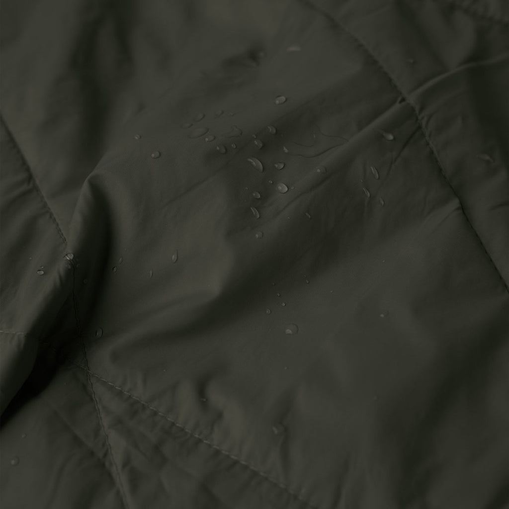 Close-up of Layover™ XL Travel Blanket | Spruce fabric with droplets