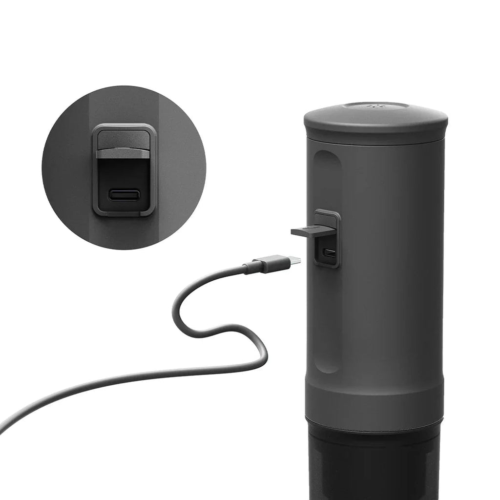 Black electronic device with USB cable and close-up of charging port on a white background