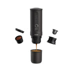 Black portable coffee maker with components on a white background