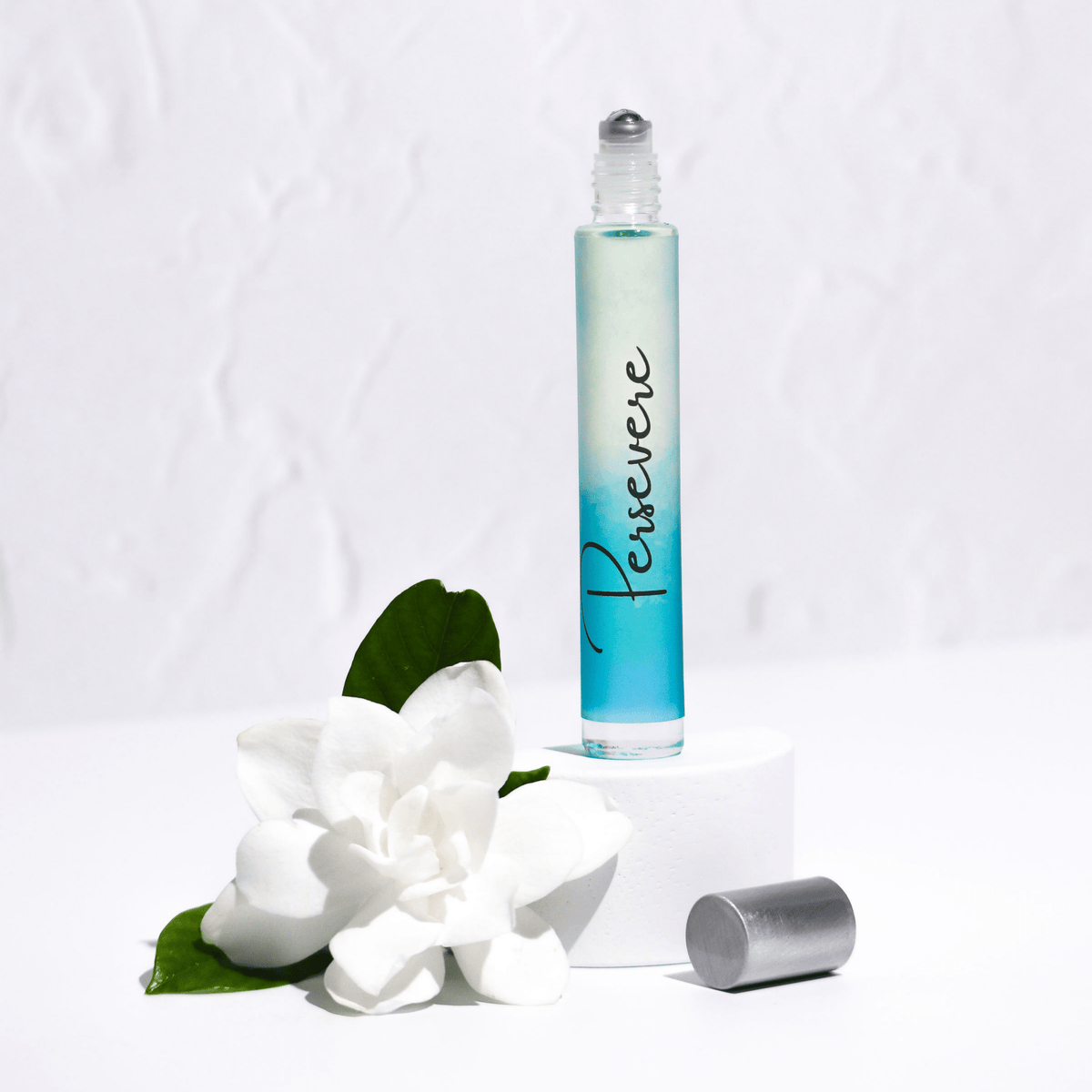 Roll-on bottle labeled 'Persevere' with a white flower on a light gray background