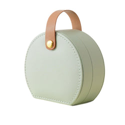 Green round jewelry storage box with leather handle