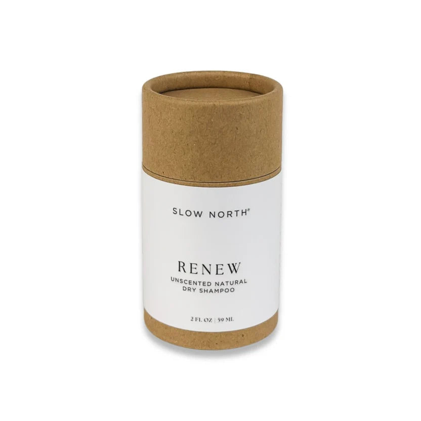 Paper container with white label for 'Slow North Renew' dry shampoo on a white background