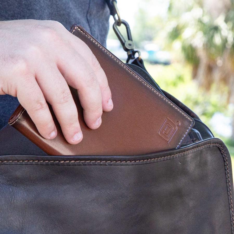 RFID Blocking Leather Passport Wallet being placed in a bag.