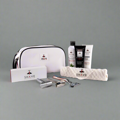Shaving kit with white bag, razors, and bottles on a dark green background