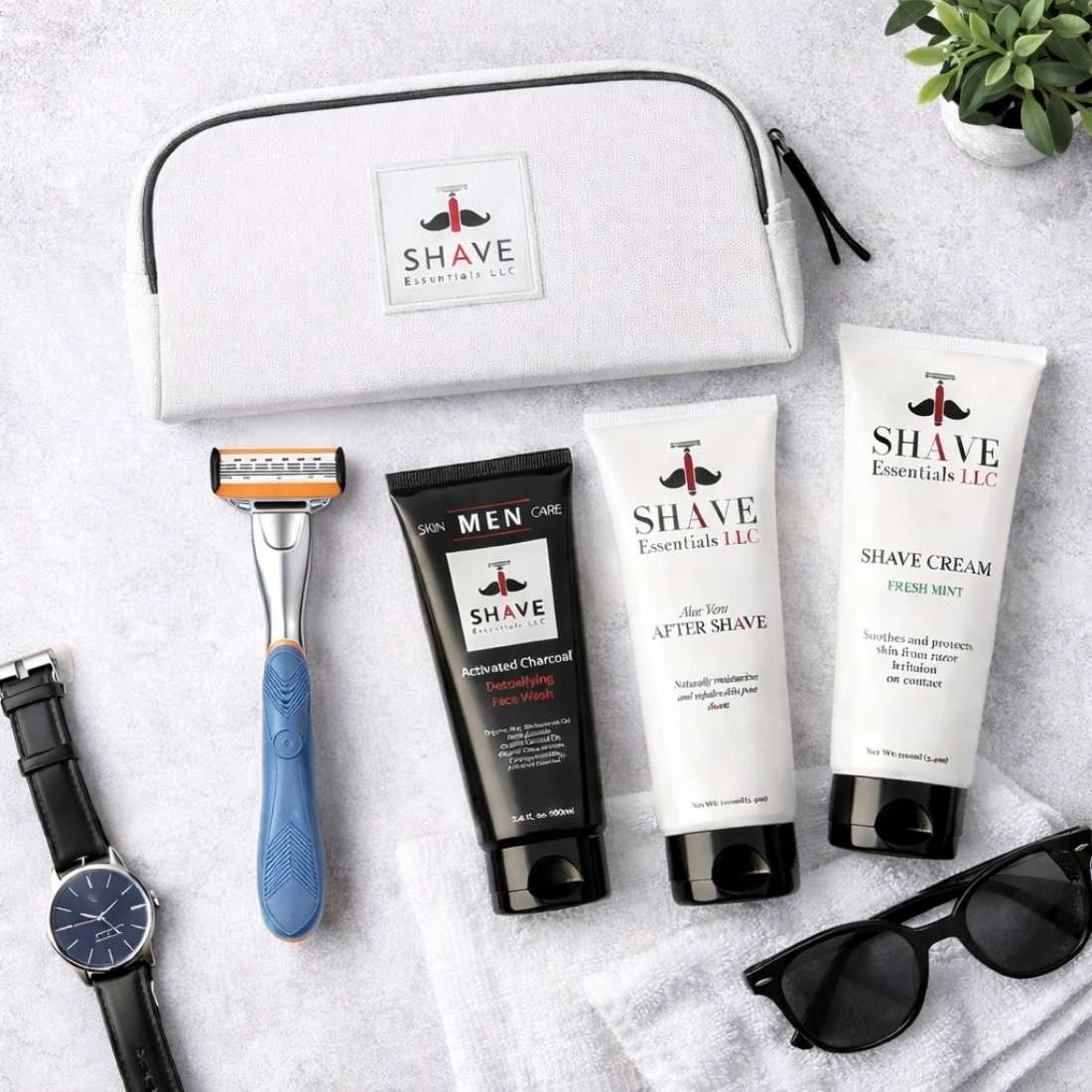 Shave essentials set with razor, cream, and after-shave on a white surface.