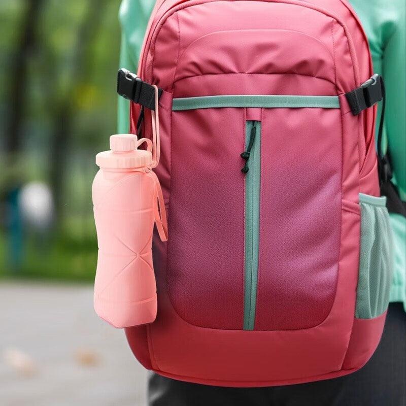The 600ml Collapsible Adventure Bottle attached to a backpack