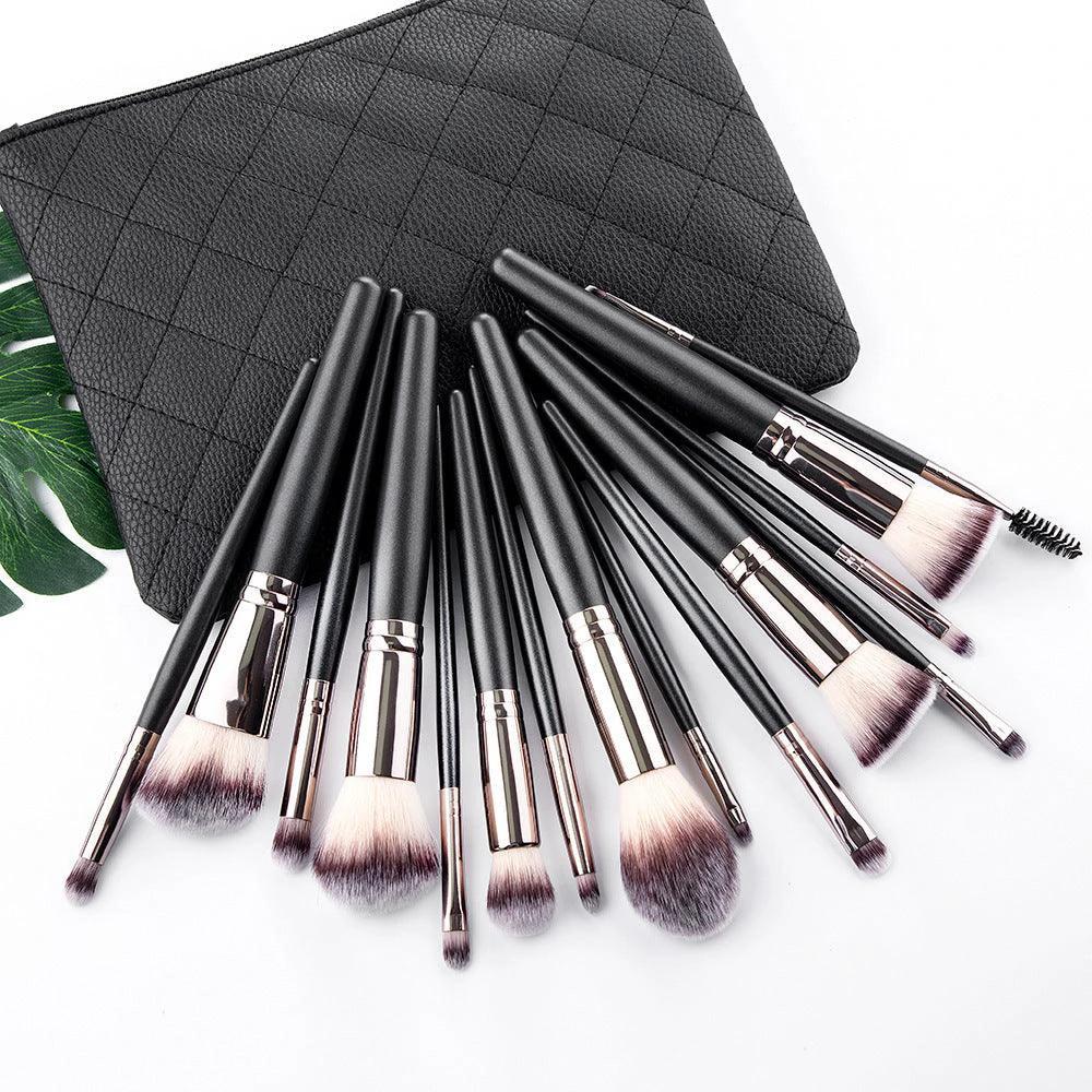 The Essentials 15-Piece Matte Black Makeup Brush Set in a sleek pouch.