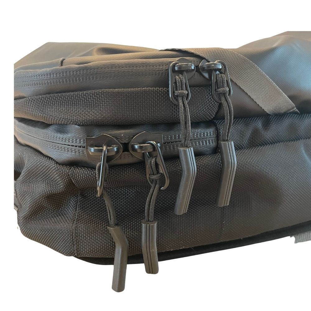 Gray tactical pouch with multiple zippers and straps on a white background