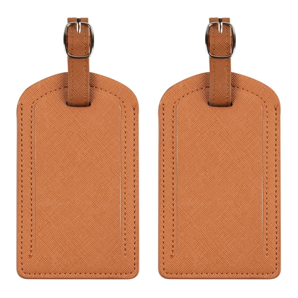 The Luggage Tag in stylish orange PU leather for travel.