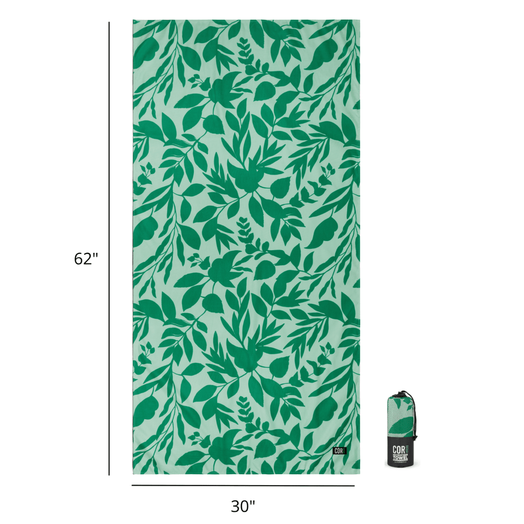 Green leaf patterned towel with dimensions and a folded towel on a white background