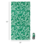 Green leaf patterned towel with dimensions and a folded towel on a white background