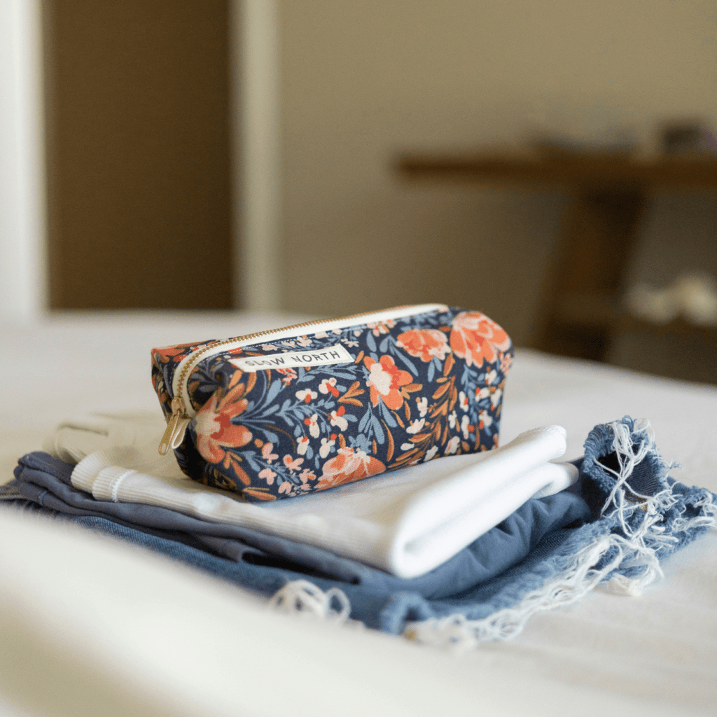 Travel Pouch - Pom Blossom with travel size essentials.