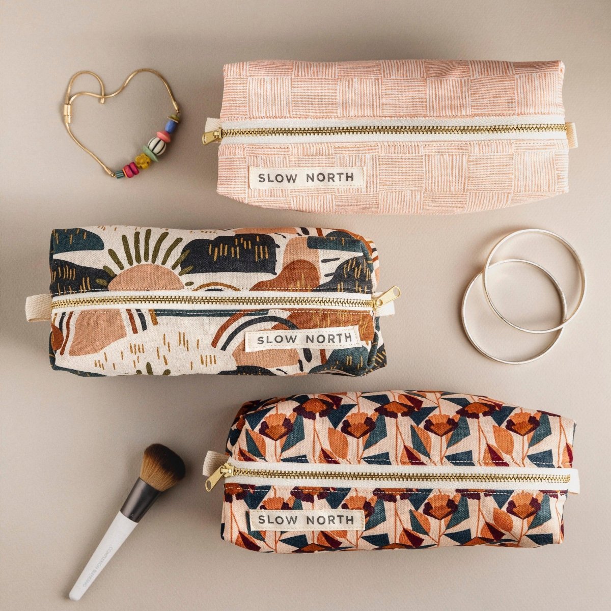 Travel Pouch - Rainbow Hil with colorful designs and gold zippers