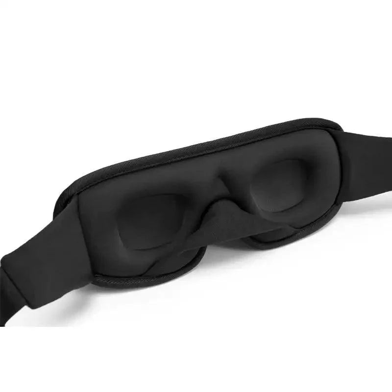 The back of a sleep mask on a white background, showing the flap that blocks light from the nose region.