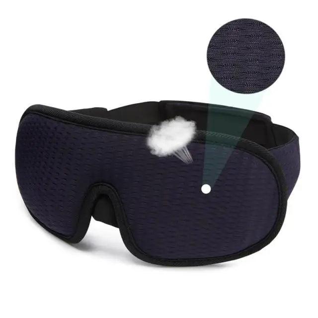 Navy sleep mask with a close-up of the breathable mesh fabric on a white background.